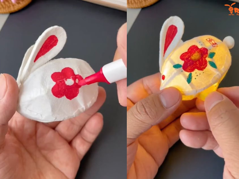 Sử dụng bút màu để vẽ mắt, mũi và miệng cho thỏ, bạn có thể sử dụng bút màu acrylic để màu lâu trôi hơn